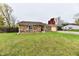 Brick ranch house with a large yard and mature trees at 7922 S Sherman Dr, Indianapolis, IN 46237