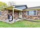 Brick ranch house with a covered porch and well-maintained lawn at 7922 S Sherman Dr, Indianapolis, IN 46237
