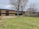 Large backyard with a grassy area and a view of a school building at 310 S Pleasant St, Edinburgh, IN 46124