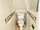 Small bathroom with toilet and grab bars at 310 S Pleasant St, Edinburgh, IN 46124