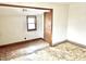 Empty bedroom with damaged flooring and a door at 310 S Pleasant St, Edinburgh, IN 46124