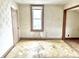 Small bedroom needing renovation, features a window and damaged flooring at 310 S Pleasant St, Edinburgh, IN 46124