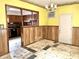 Simple dining room with wood paneling and yellow walls at 310 S Pleasant St, Edinburgh, IN 46124