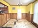 Dining room features wood paneling, yellow walls and a window at 310 S Pleasant St, Edinburgh, IN 46124