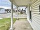 Quaint front porch with white columns, offering a relaxing view of the street at 310 S Pleasant St, Edinburgh, IN 46124