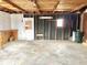 Unfinished garage featuring a door and ample space for storage at 310 S Pleasant St, Edinburgh, IN 46124