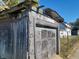 Detached garage with weathered wood siding and damaged roof at 310 S Pleasant St, Edinburgh, IN 46124