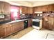 Kitchen with wood cabinets, brick backsplash, and gas range at 310 S Pleasant St, Edinburgh, IN 46124
