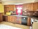Kitchen with wood cabinets, brick backsplash and appliances at 310 S Pleasant St, Edinburgh, IN 46124