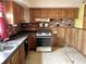 Kitchen with wood cabinets, brick backsplash and appliances at 310 S Pleasant St, Edinburgh, IN 46124