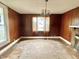 Living room with wood paneled walls and hardwood floors at 310 S Pleasant St, Edinburgh, IN 46124