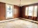 Spacious living room with wood paneling and hardwood floors, ready for updates at 310 S Pleasant St, Edinburgh, IN 46124