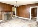 Living room with wood paneled walls and hardwood floors at 310 S Pleasant St, Edinburgh, IN 46124