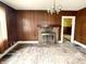 Living room with wood paneled walls and fireplace at 310 S Pleasant St, Edinburgh, IN 46124