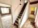 Entrance staircase with worn wooden steps and railing at 310 S Pleasant St, Edinburgh, IN 46124