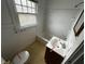 Bathroom with a tub, sink, and toilet, needing updates at 3435 Carrollton Ave, Indianapolis, IN 46205
