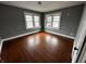 Bedroom with hardwood floors, gray walls and two windows at 3435 Carrollton Ave, Indianapolis, IN 46205