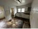 Small kitchen needing updates, features white cabinets and a double sink at 3435 Carrollton Ave, Indianapolis, IN 46205
