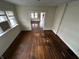 Living room with hardwood floors and access to other rooms at 3435 Carrollton Ave, Indianapolis, IN 46205