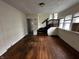 Living room with hardwood floors and an open staircase at 3435 Carrollton Ave, Indianapolis, IN 46205