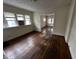 Living room with hardwood floors and view into another room at 3435 Carrollton Ave, Indianapolis, IN 46205