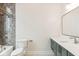 Bathroom with a green vanity, white quartz countertop, and gray tile shower at 41 N Rangeline Rd # 7, Carmel, IN 46032
