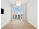 Bedroom with hardwood floors and access to balcony at 41 N Rangeline Rd # 7, Carmel, IN 46032