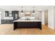 Modern kitchen with large island, white and dark cabinets, and wine cooler at 41 N Rangeline Rd # 7, Carmel, IN 46032