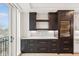 Dark kitchen cabinets and quartz countertops with a built-in wine fridge at 41 N Rangeline Rd # 7, Carmel, IN 46032
