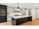Modern kitchen island with dark cabinets and white quartz countertop at 41 N Rangeline Rd # 7, Carmel, IN 46032
