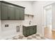 Laundry room with green cabinets, quartz countertop, and black faucet at 41 N Rangeline Rd # 7, Carmel, IN 46032