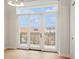 Living room with hardwood floors and sliding doors leading to a balcony with city view at 41 N Rangeline Rd # 7, Carmel, IN 46032