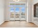 Living room with hardwood floors and sliding doors leading to a private balcony at 41 N Rangeline Rd # 7, Carmel, IN 46032