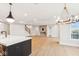 Open living room with hardwood floors, fireplace, and large windows at 41 N Rangeline Rd # 7, Carmel, IN 46032