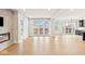 Bright living room featuring hardwood floors and access to a balcony at 41 N Rangeline Rd # 7, Carmel, IN 46032