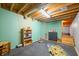 Finished basement playroom with built-in shelving and stairs to additional space at 6465 Mt Moriah Rd, Nineveh, IN 46164