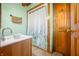 Clean bathroom with a shower/tub combo, vanity, and wood accents at 6465 Mt Moriah Rd, Nineveh, IN 46164