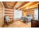 Cozy bedroom with log cabin walls, hardwood floors, and a rocking chair at 6465 Mt Moriah Rd, Nineveh, IN 46164