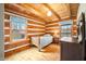 Small bedroom with log cabin walls, hardwood floors, and twin bed at 6465 Mt Moriah Rd, Nineveh, IN 46164