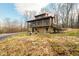 Two-story log cabin with screened porch and stone foundation at 6465 Mt Moriah Rd, Nineveh, IN 46164
