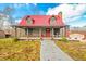 Charming log cabin with red metal roof, porch, and landscaping at 6465 Mt Moriah Rd, Nineveh, IN 46164