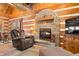 Stone fireplace in a cozy log cabin living room at 6465 Mt Moriah Rd, Nineveh, IN 46164