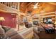 Spacious living room with stone fireplace and log cabin details at 6465 Mt Moriah Rd, Nineveh, IN 46164