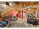 Open living room with log cabin details and loft area at 6465 Mt Moriah Rd, Nineveh, IN 46164
