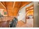 Upstairs loft area with wood beams, a desk, and a view into a bedroom at 6465 Mt Moriah Rd, Nineveh, IN 46164