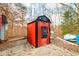 Red outdoor wood boiler with black chimney and metal siding at 6465 Mt Moriah Rd, Nineveh, IN 46164