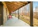 Covered patio with stone flooring and red chairs at 6465 Mt Moriah Rd, Nineveh, IN 46164