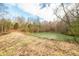 Serene pond nestled in a wooded area with a grassy bank at 6465 Mt Moriah Rd, Nineveh, IN 46164