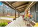 Covered porch overlooking wooded area, furnished with seating at 6465 Mt Moriah Rd, Nineveh, IN 46164