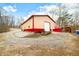Tan and red metal workshop with overhead door and gravel driveway at 6465 Mt Moriah Rd, Nineveh, IN 46164